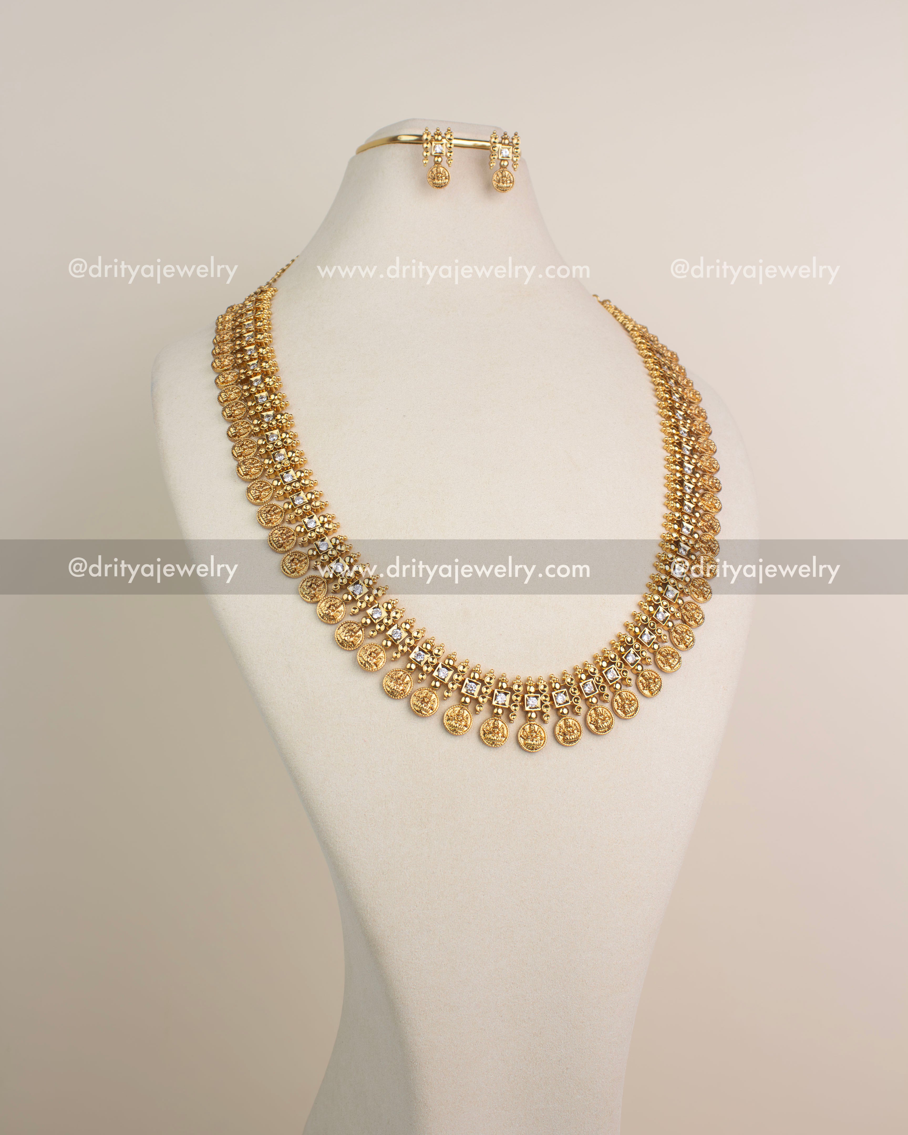 Full view of premium temple kasulu long necklace with CZ stones and matching earrings in gold polish.