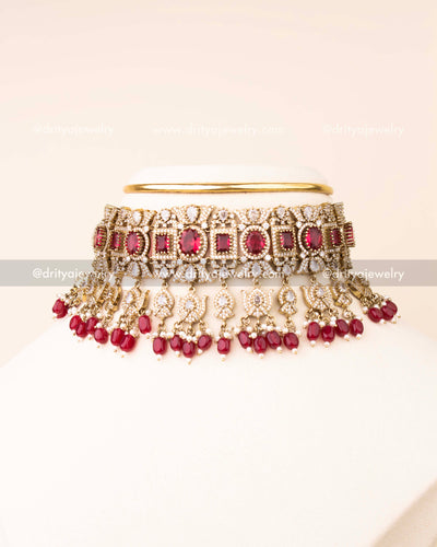 Luxurious ruby red bridal choker with AD stones and matching earrings.