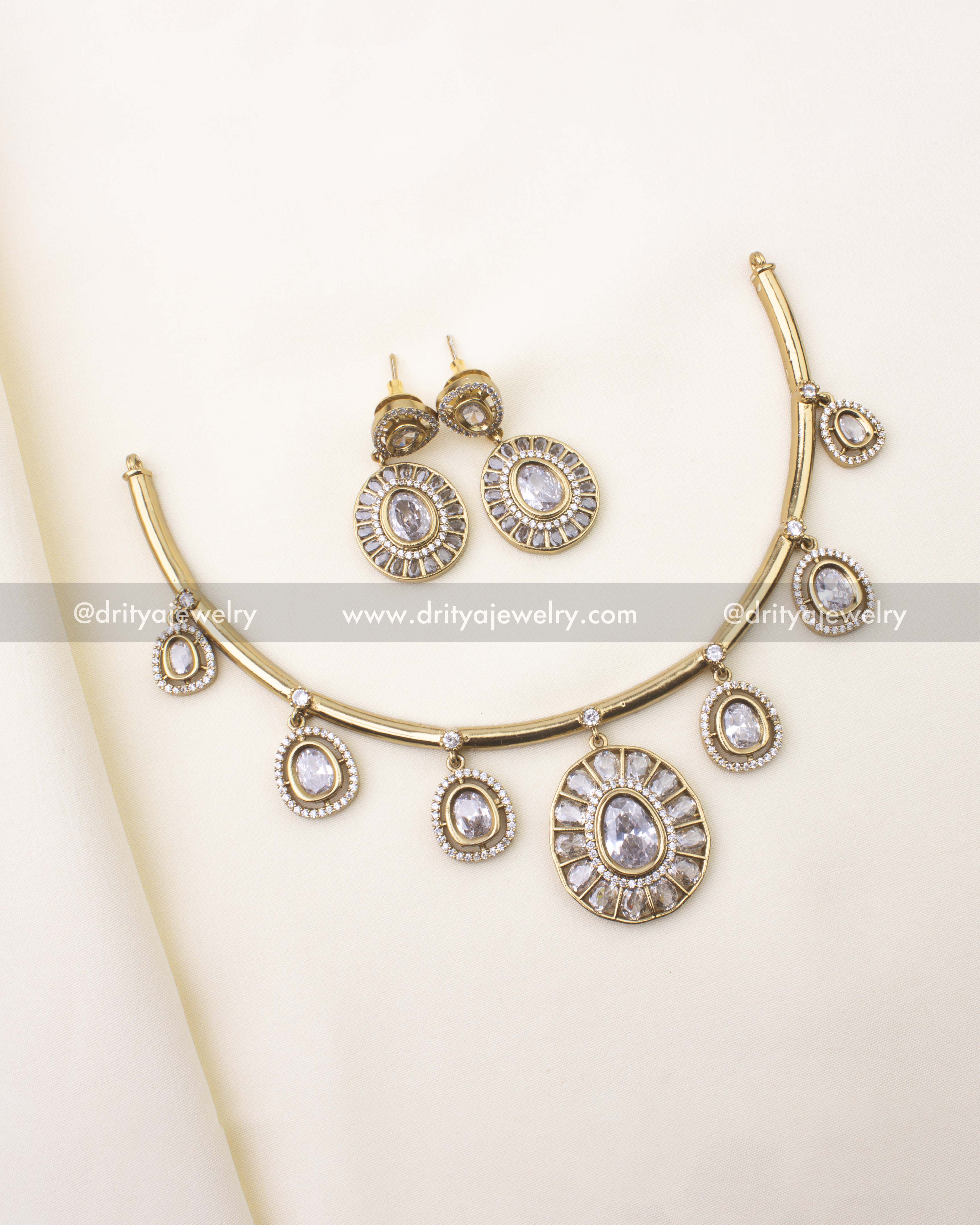 Full Premium White Hasli Necklace Set with earrings displayed on cream fabric