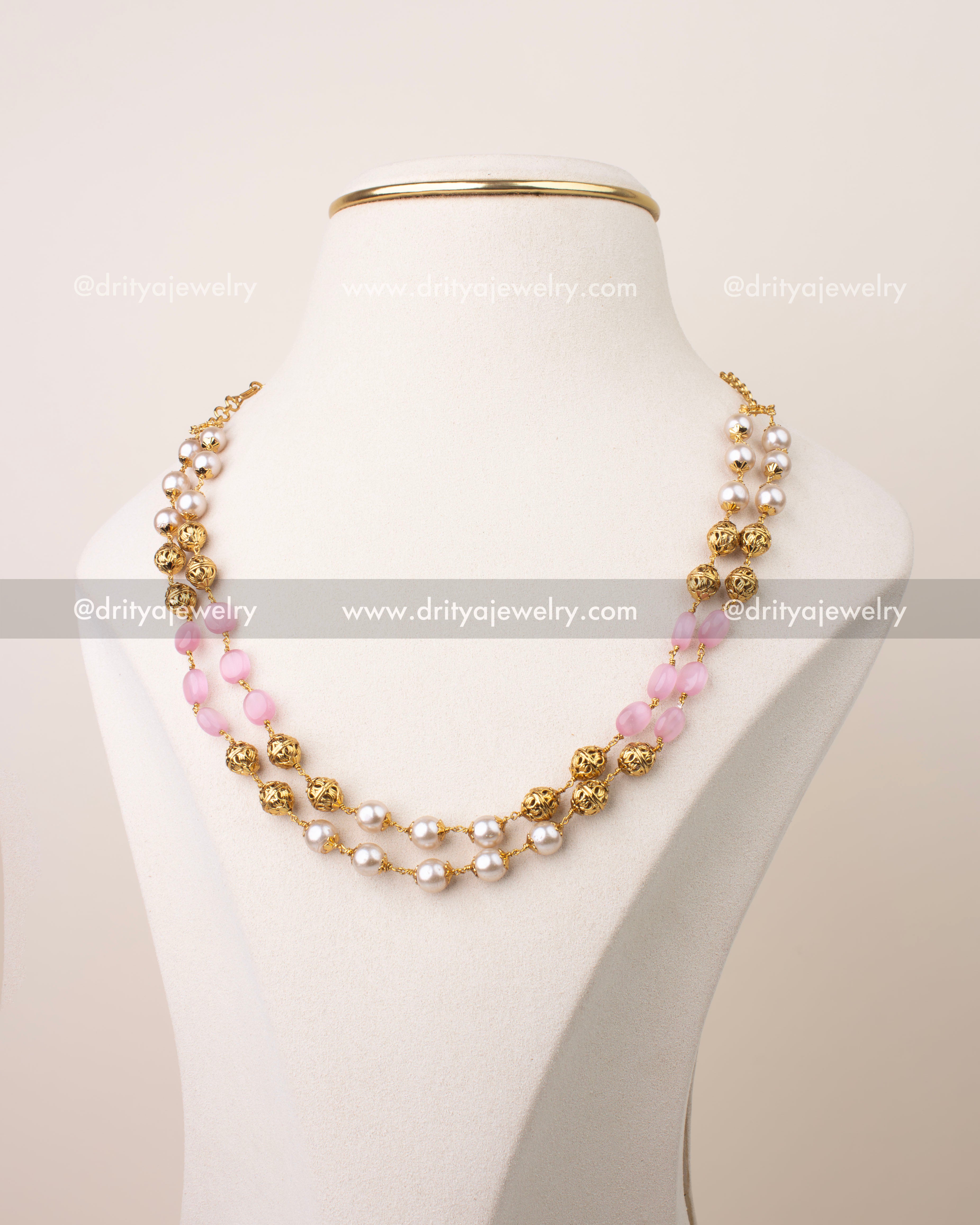 Double layer mala necklace with blush pink beads, gold filigree balls, and pearl detailing