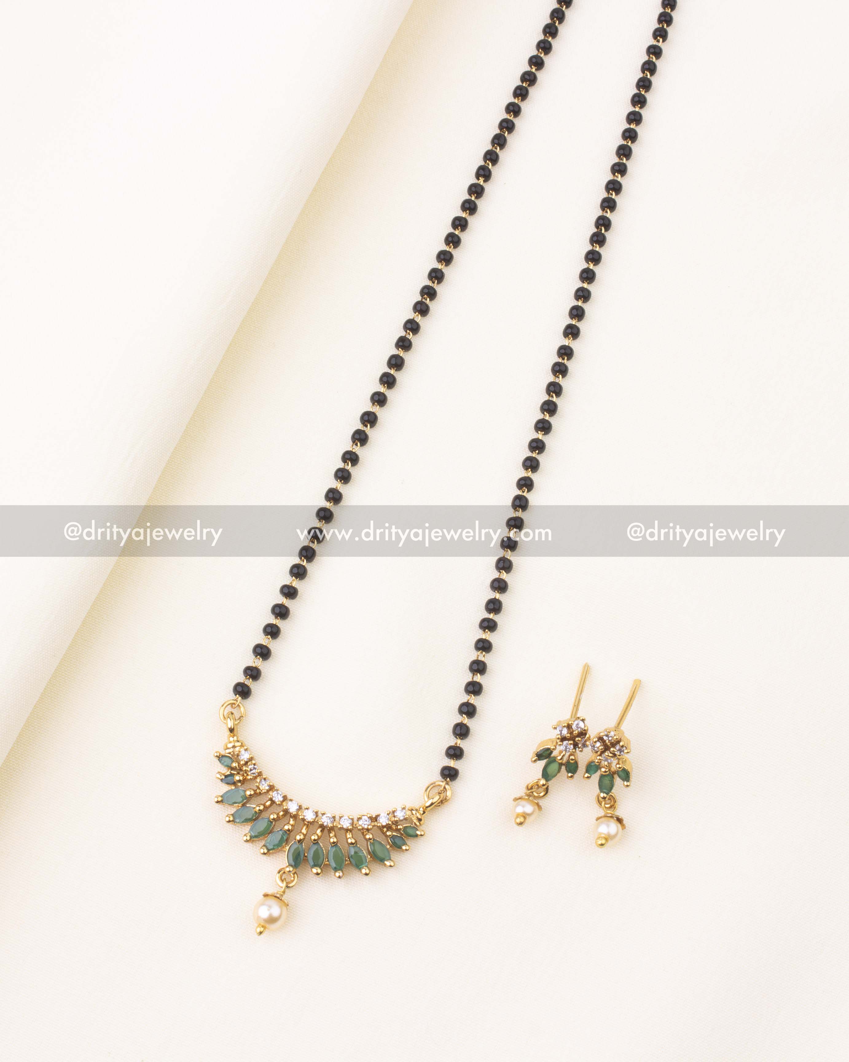 18-inch black beads necklace with green stones, CZ sparkle, and matching earrings.
