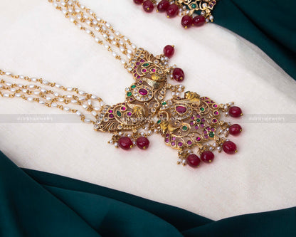 Luxurious gold-plated necklace set with rice beads and colorful gemstone accents, ideal for weddings and festive occasions.