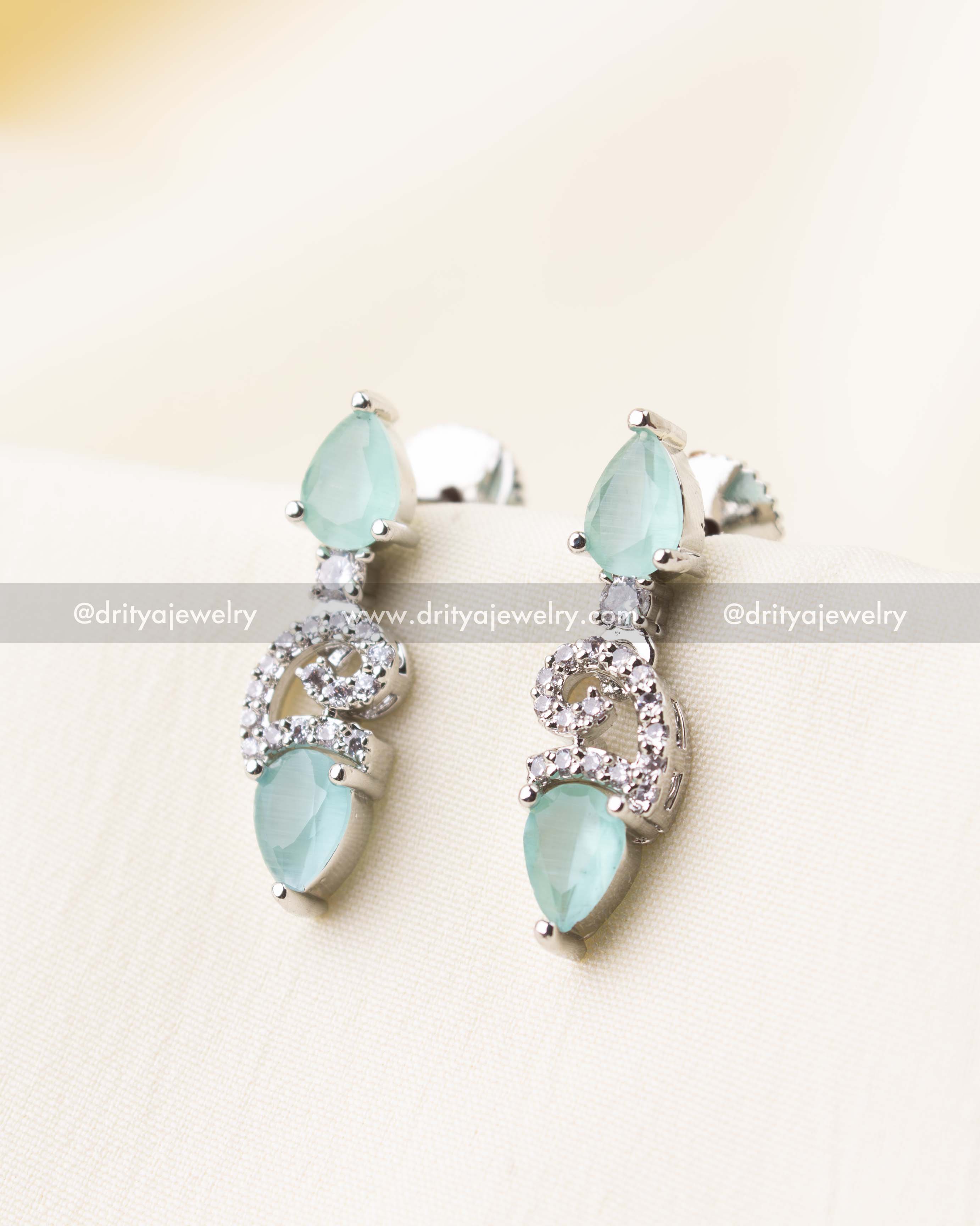 Elegant aqua-toned drop earrings featuring sparkling zircon and pastel blue stones.