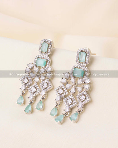 Dangling earrings featuring aqua stones and pear-shaped zircon drops.