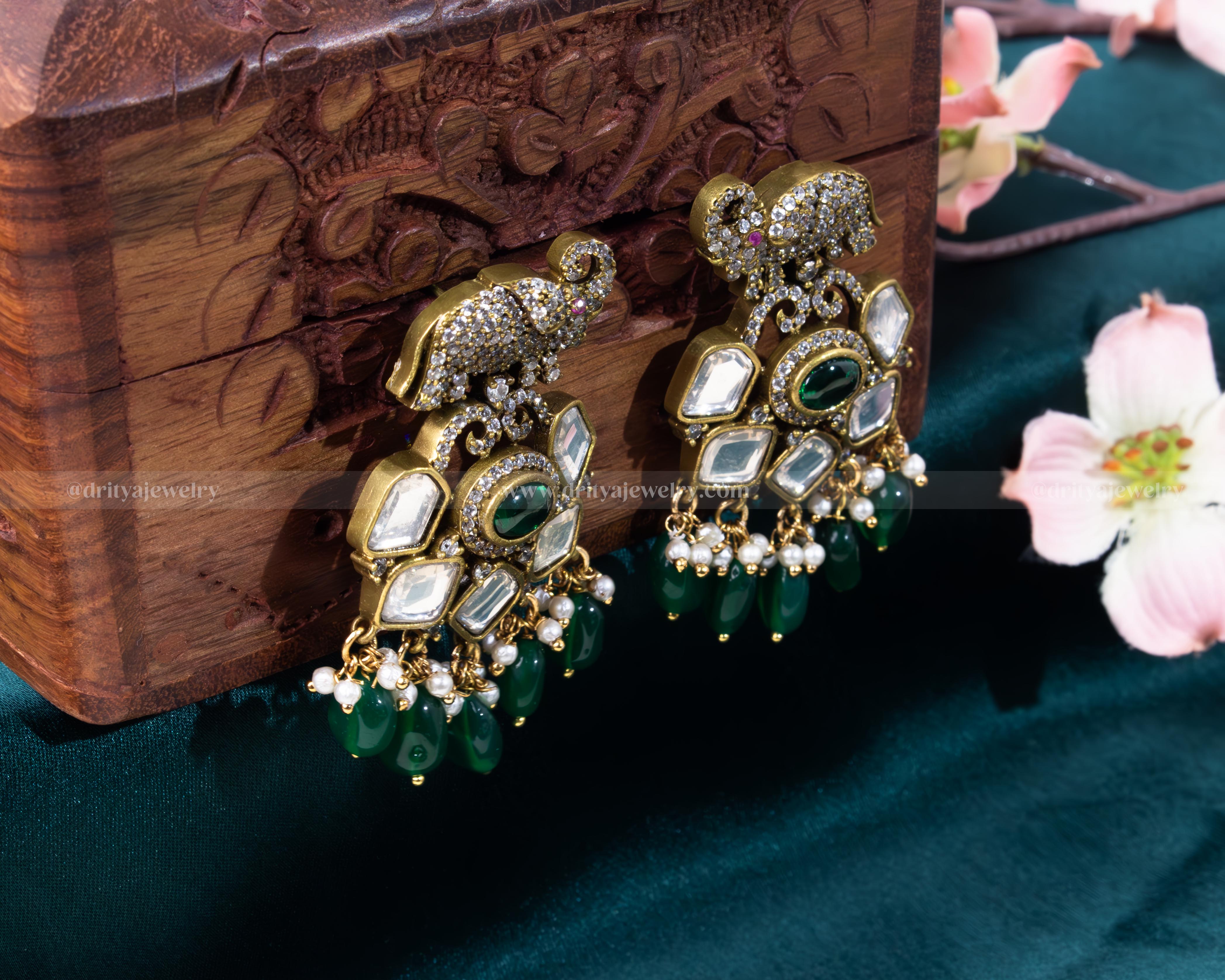 Elegant Kundan dangler earrings with green beads and pearl accents by Dritya Jewelry.