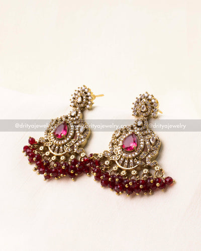 Victorian-style earrings with ruby-colored AD stones and bead hangings.