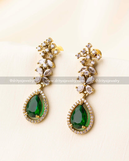 Matching long earrings with emerald green stones and CZ floral detailing