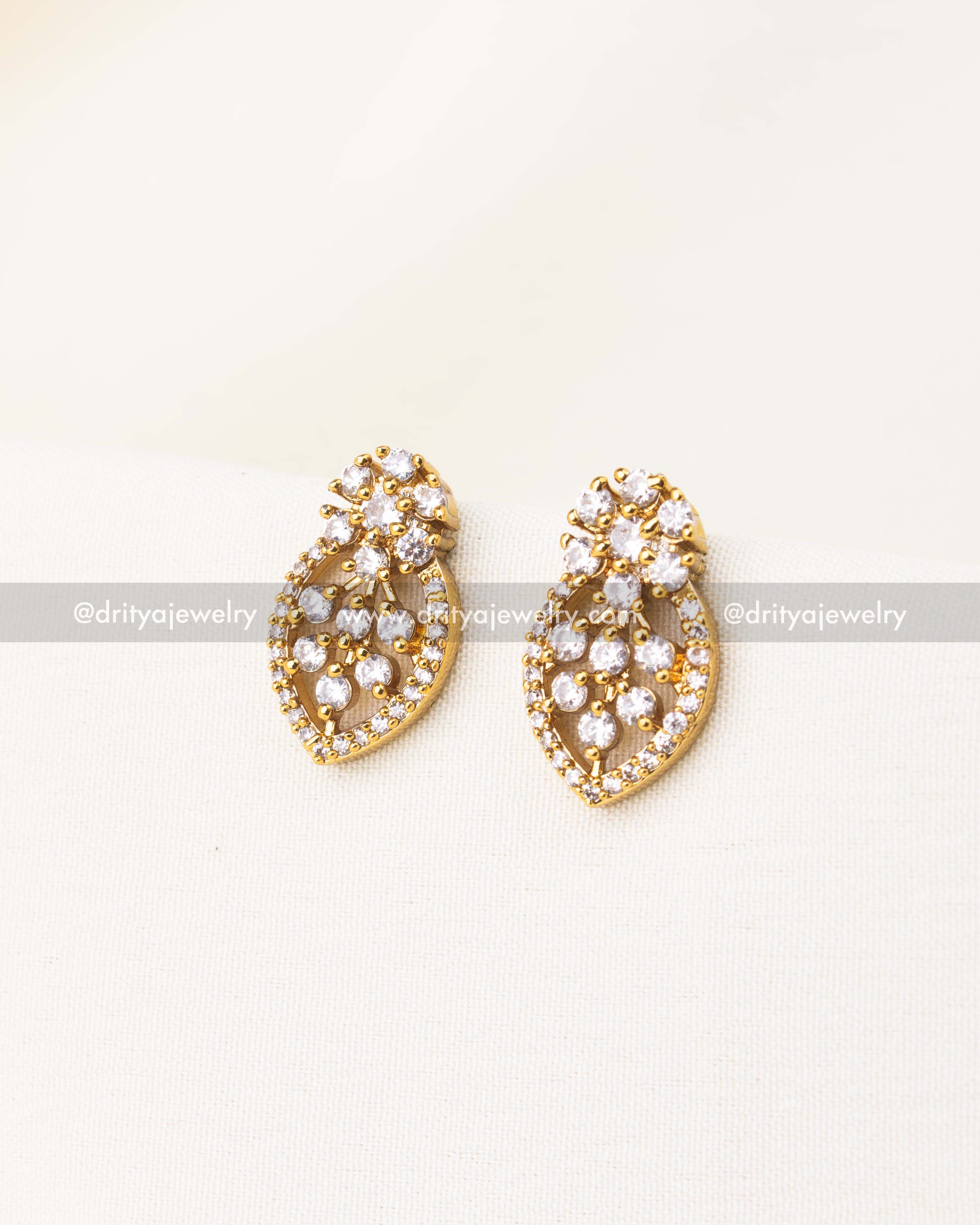 Teardrop-shaped CZ earrings paired with black beads necklace.