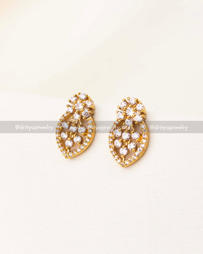 Teardrop-shaped CZ earrings paired with black beads necklace.