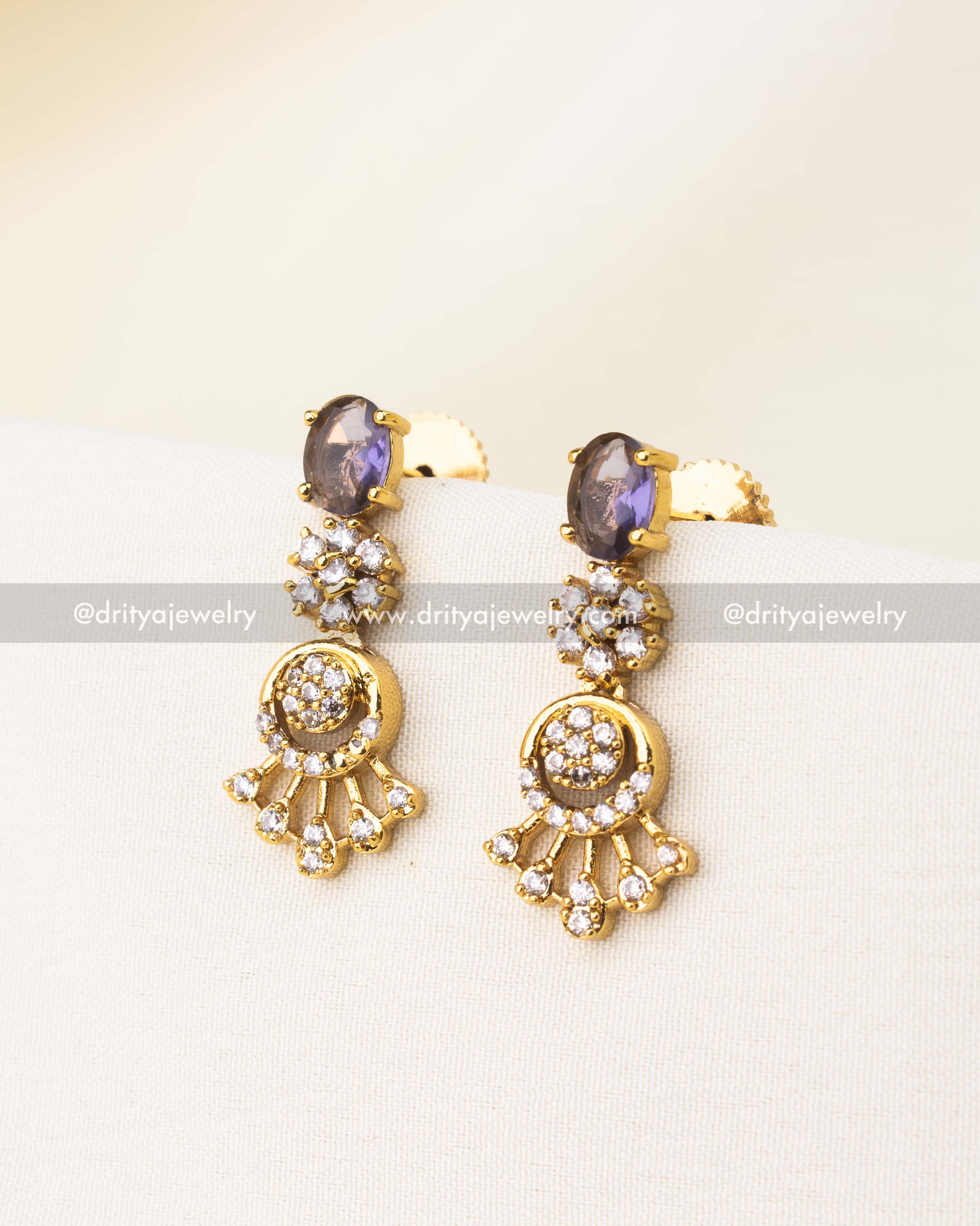 Gold-plated earrings with oval purple stones and CZ detailing.