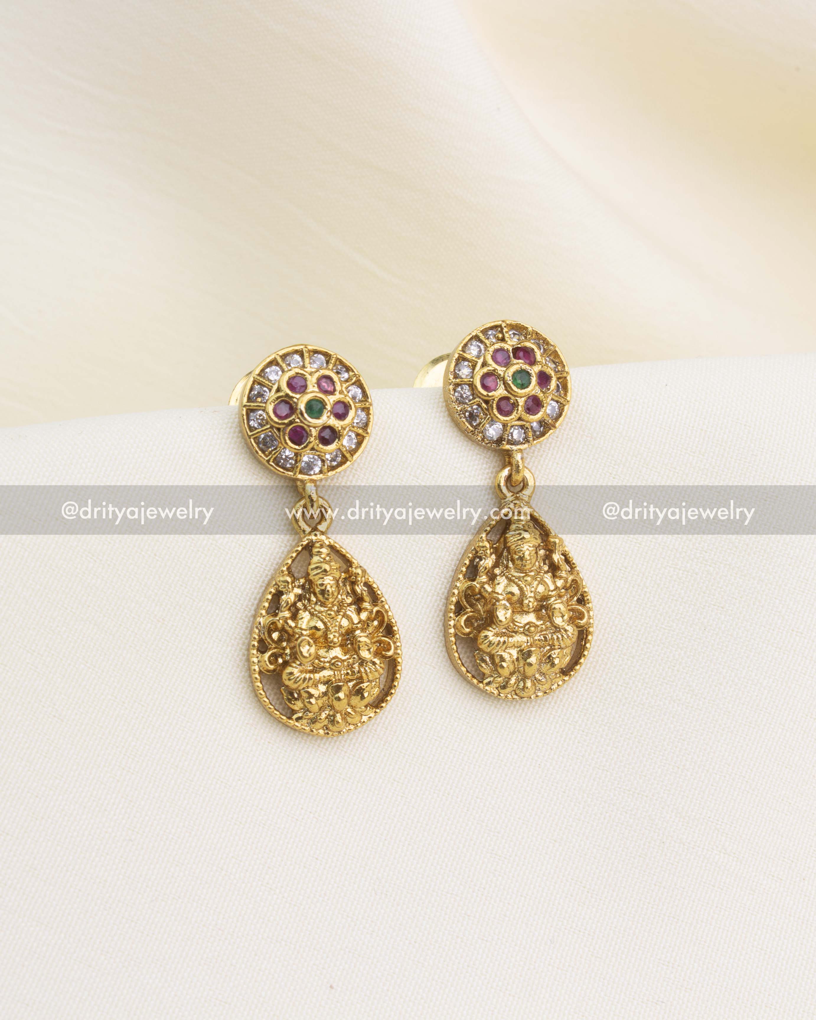 Gold-plated earrings featuring embossed Lakshmi drops and CZ floral top design.