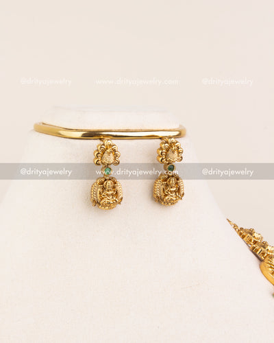 Temple-style stud earrings with mini Lakshmi detailing and green gemstone connectors.