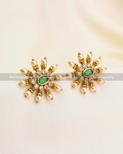 Round stud earrings with green center stones, CZ sparkle, and surrounding pearl drops.