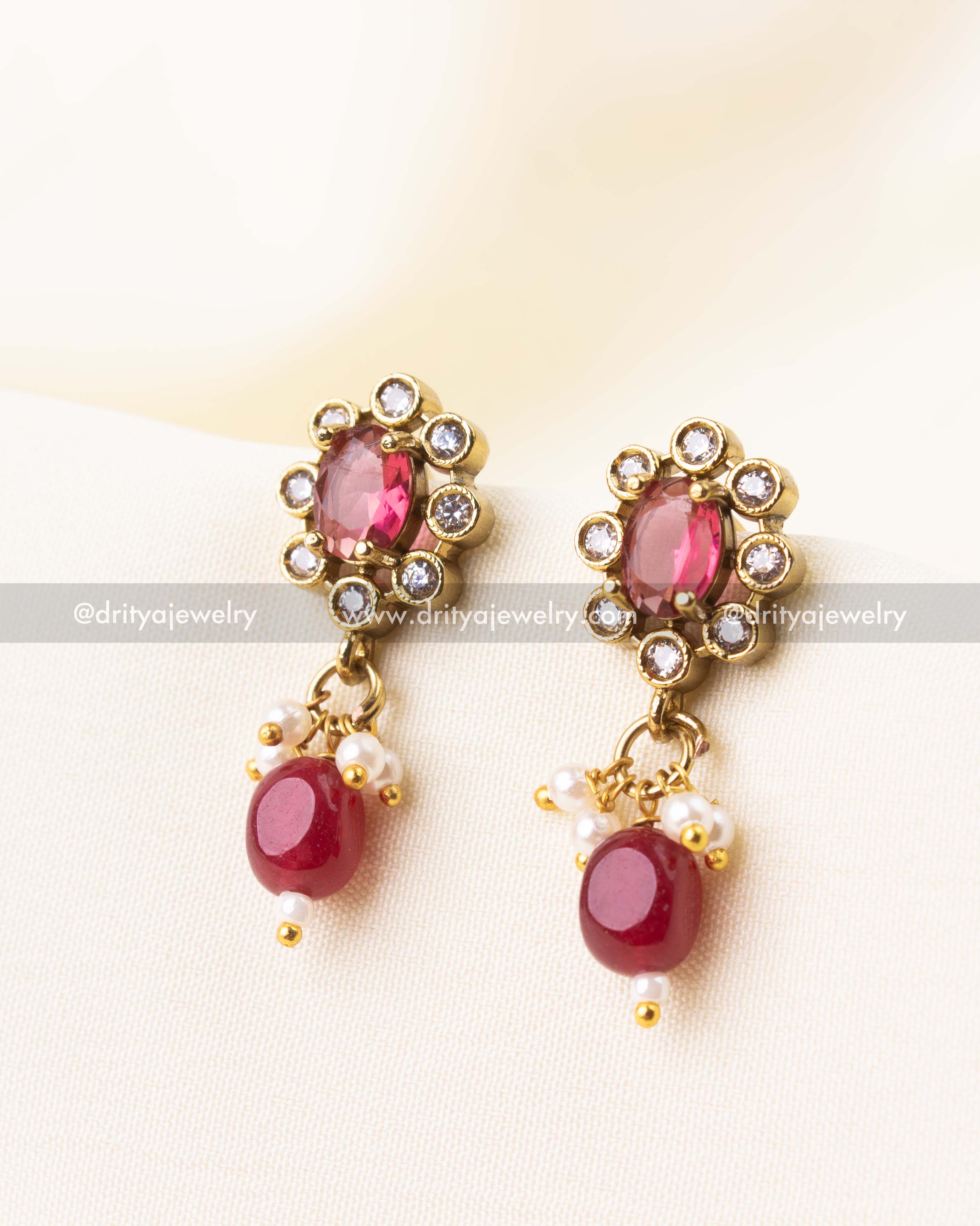 Elegant earrings with ruby center stone and pearl danglers from the choker set.