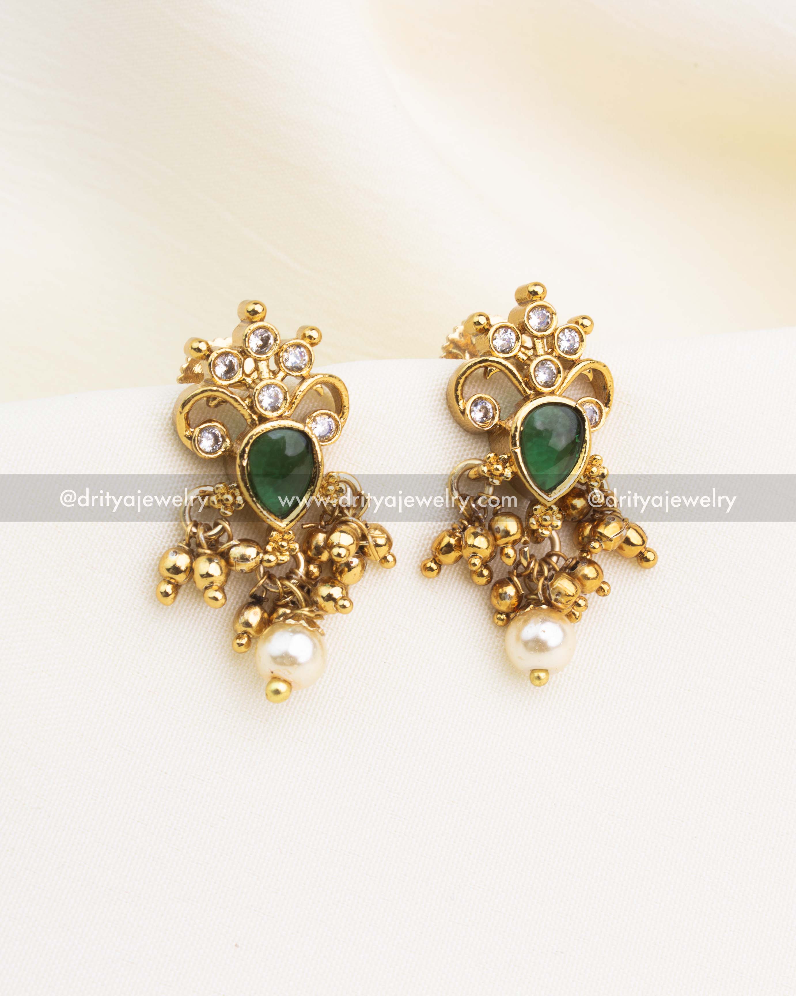 Emerald green stone earrings with pearl drops and gold-plated Nakshi detailing.