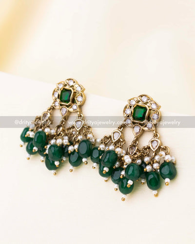 Stud earrings featuring green stones, reverse AD accents, and dangling emerald beads.