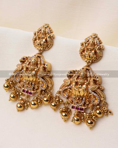 Gold-plated earrings featuring Lakshmi Devi design with bead and CZ stone details.