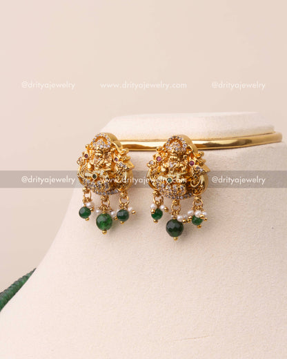 Gold-plated earrings with Goddess Lakshmi motif and emerald green bead drops.