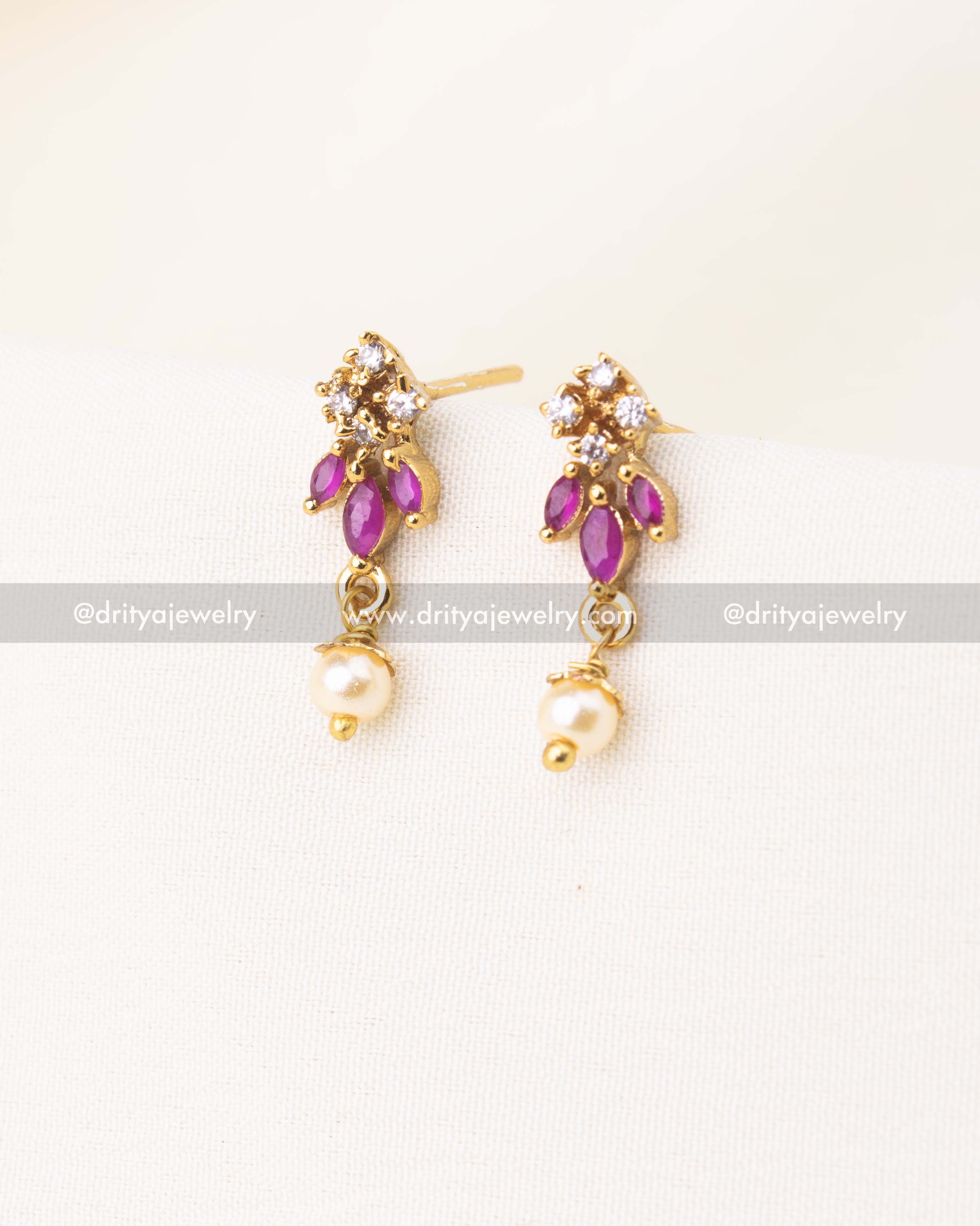 Gold-plated earrings with pink stones, CZ sparkle, and pearl danglers.