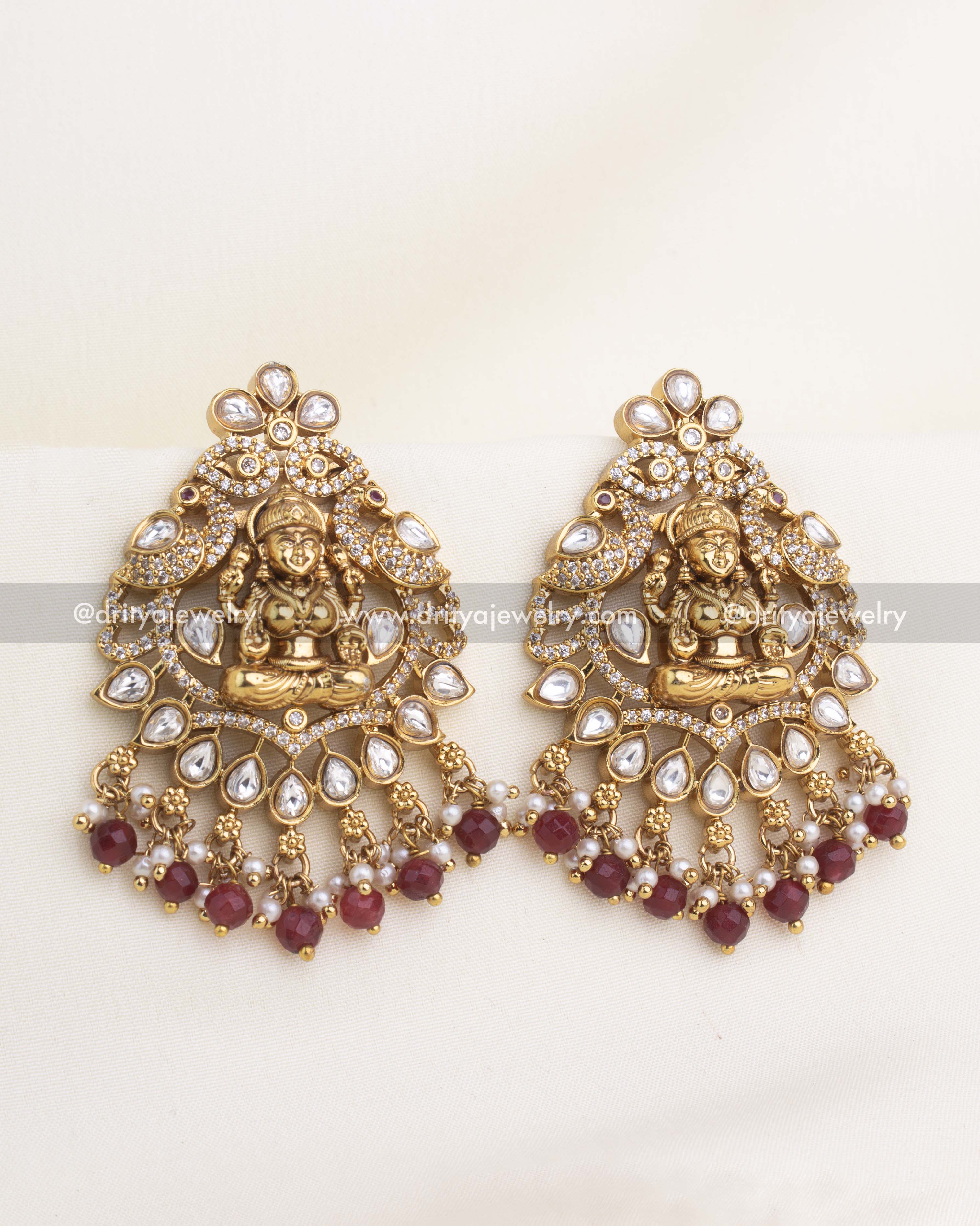 Lakshmi temple earrings with polki kundan stones, CZ highlights, and ruby bead clusters