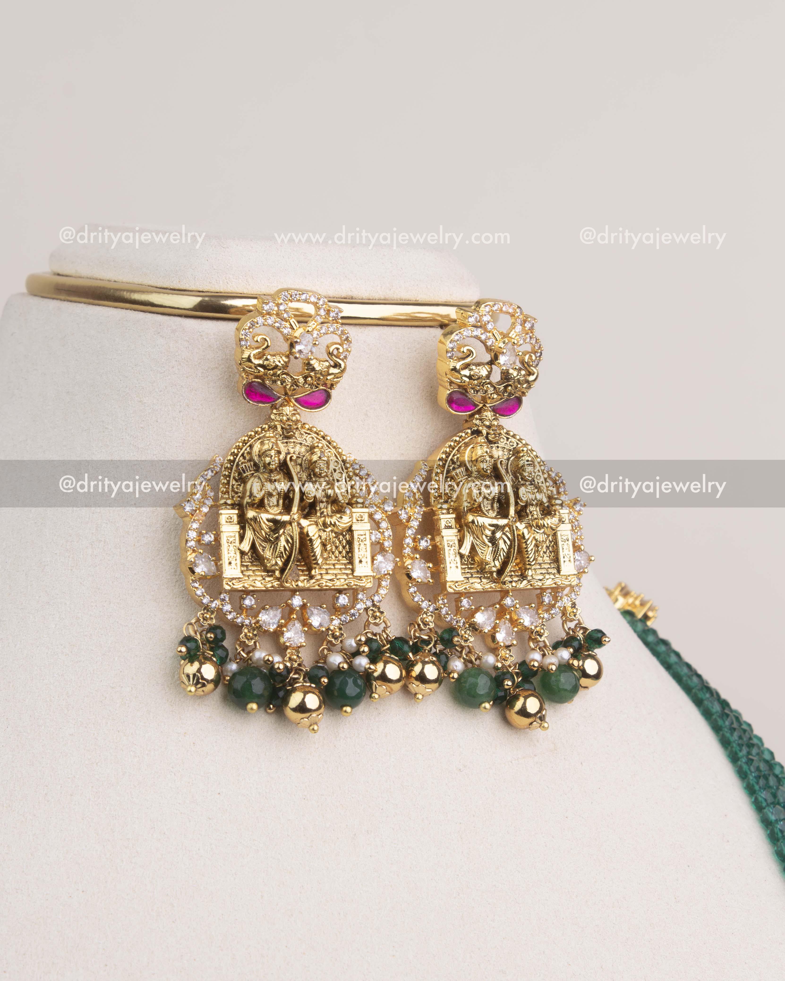 Temple-style earrings with Ram Parivar engravings, Kemp detailing, and green bead drops.