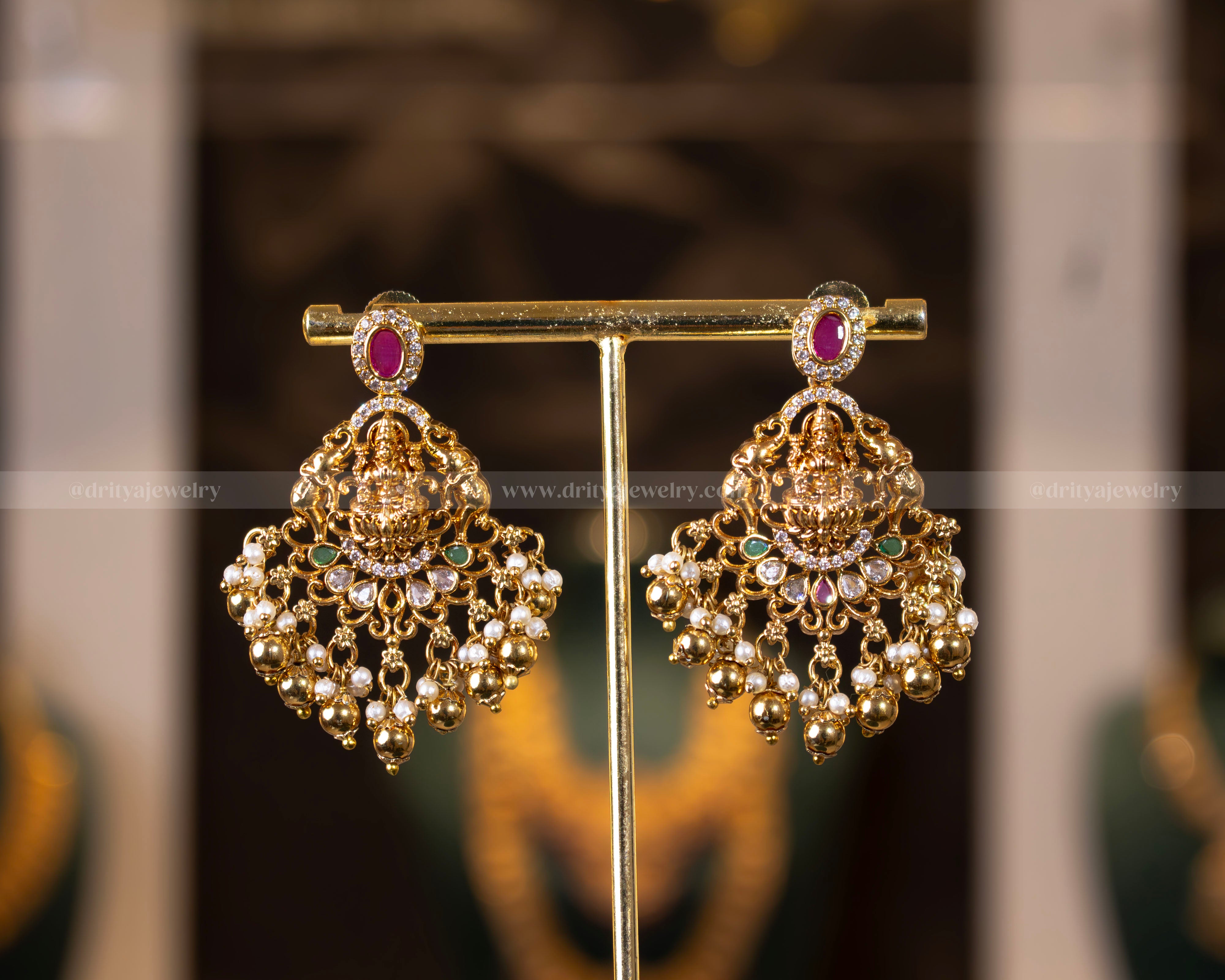 Pair of matching earrings from the Divine Lakshmi Devi Temple Necklace Set by Dritya Jewelry, adorned with pearls and precious gemstones.