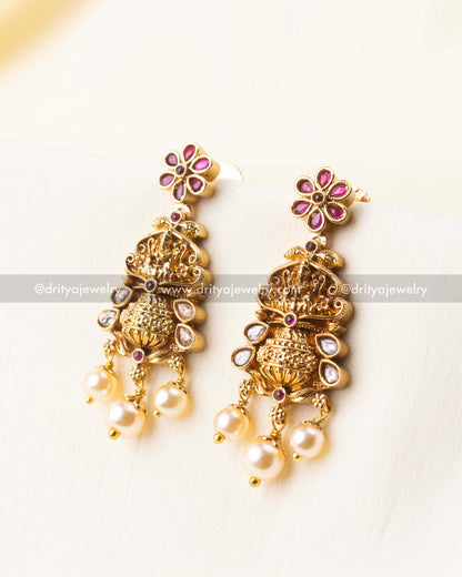 Coordinated earrings featuring deity detailing and pearl accents
