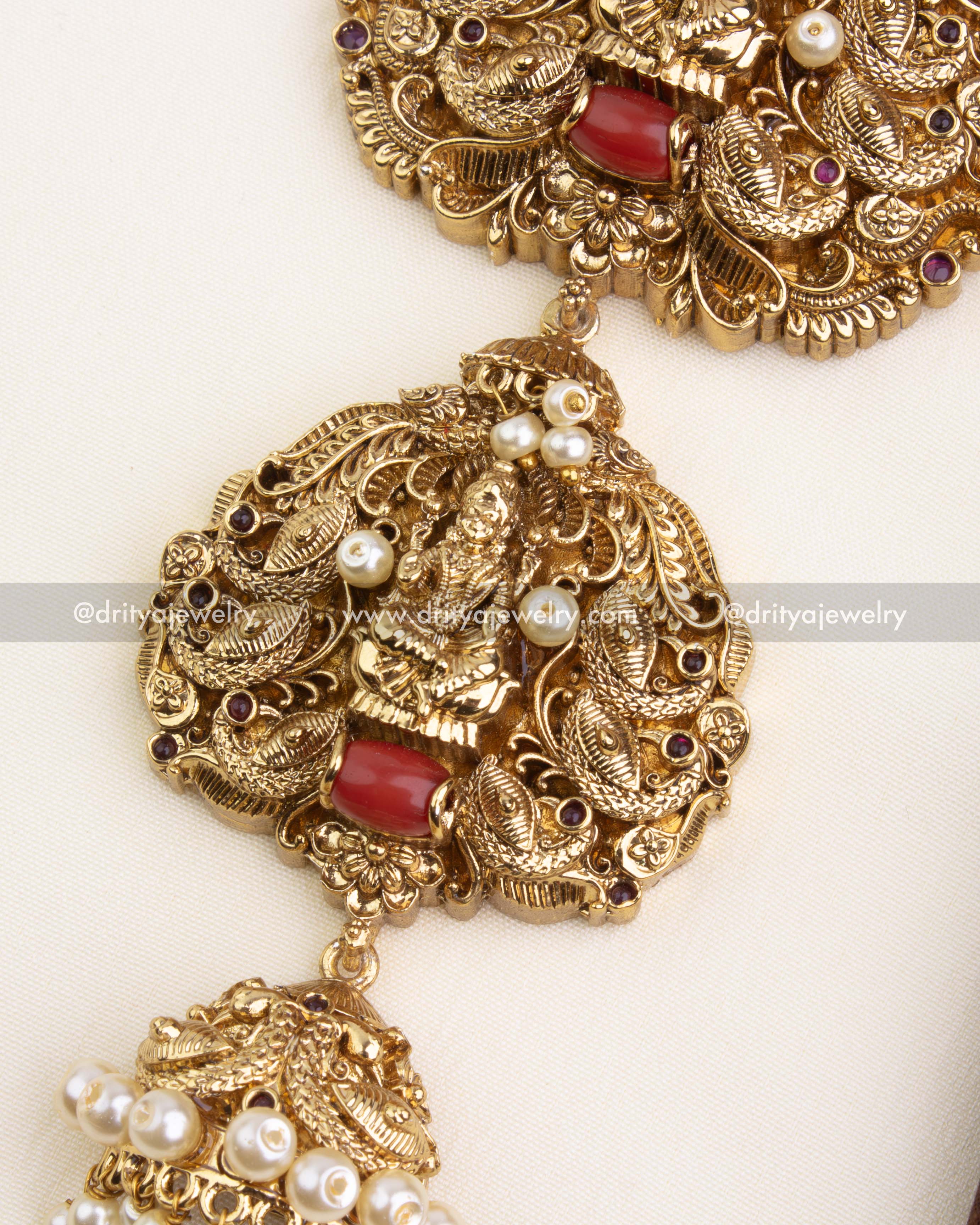 Red coral accent and jhumka-style pearl dangler on the lower tier of the jada billa