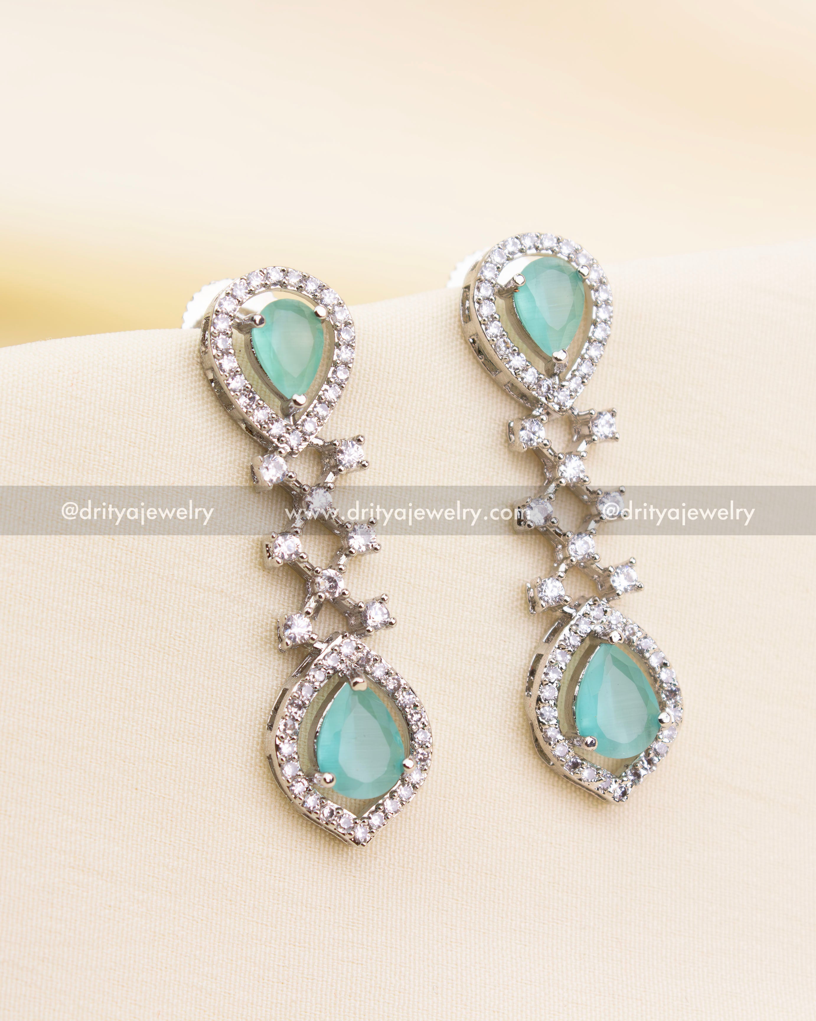 Elegant drop earrings featuring mint green stones and zircon detailing