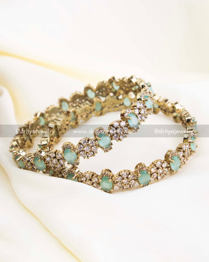 Victorian gold bangles with mint green oval stones and CZ cluster embellishments.