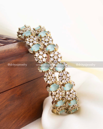 Victorian gold bangles with mint green oval stones and CZ cluster embellishments.