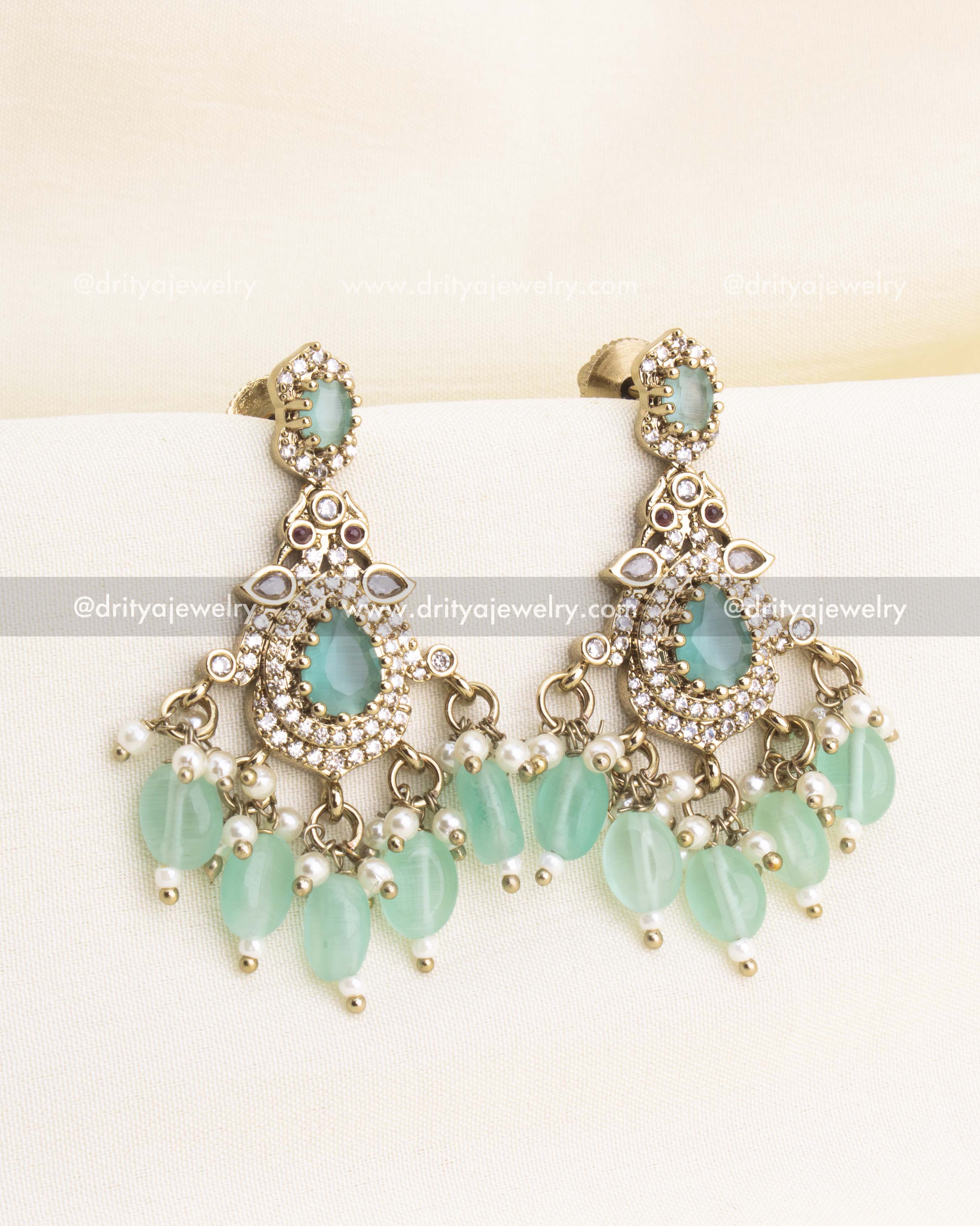 Victorian-inspired earrings featuring mint green stones, CZ work, and dangling beads.
