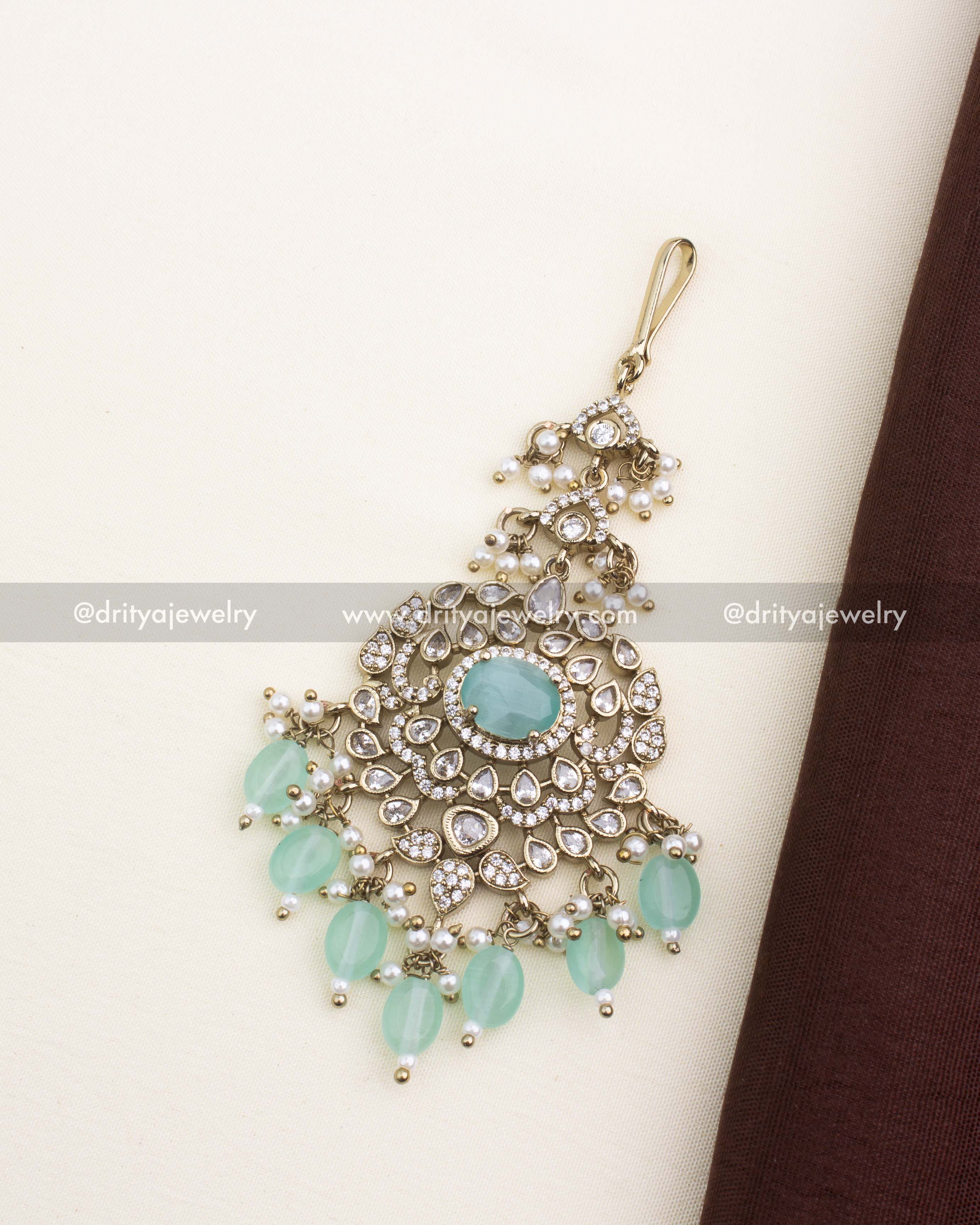 Victorian design mint stone maang tikka with AD stones, floral motifs, and pearl embellishments.