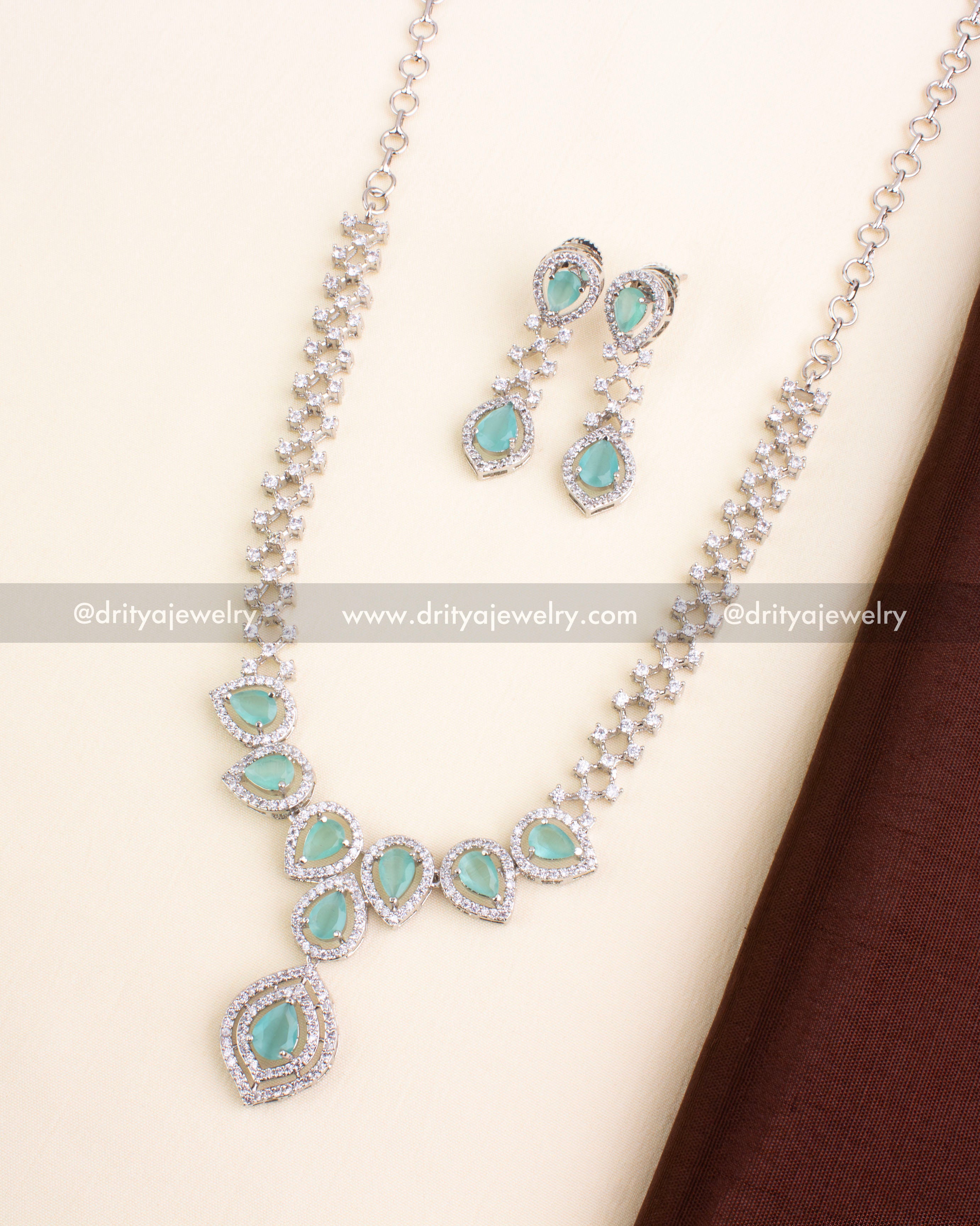 Mint green stone necklace set with AD-studded halo design and silver finish