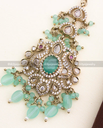 Close-up of mint green center stone, AD kundan accents, and Victorian gold finish
