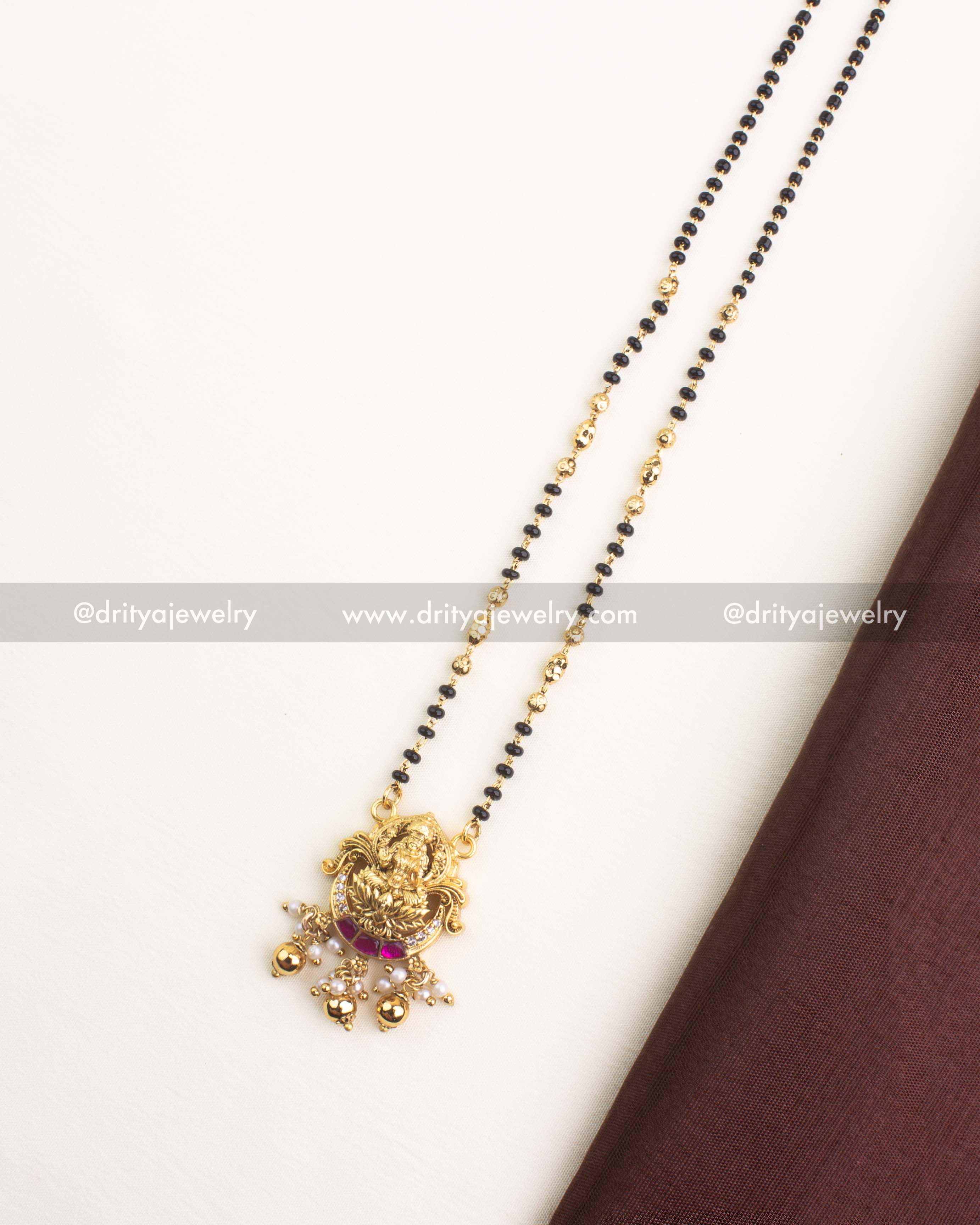 Nakshi-style pendant featuring Goddess Lakshmi with kemp butta stones, CZ accents, and pearl bead danglers.