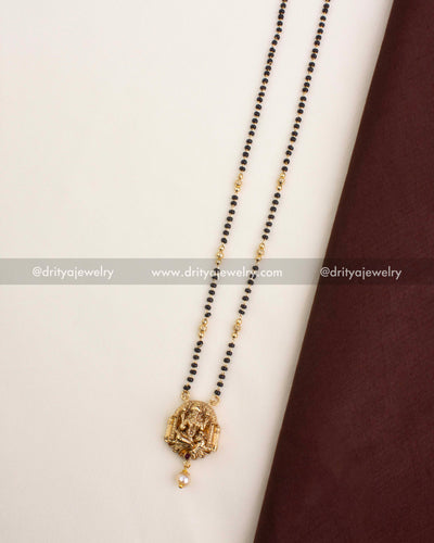 Temple-style black beads necklace featuring a Nakshi Lakshmi Devi pendant and pearl drop.