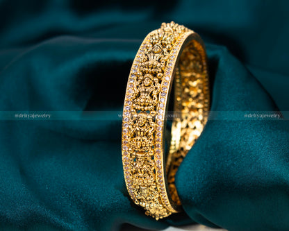 Exquisite Nakshi CZ Stone Bangle from Dritya Jewelry, featuring detailed carvings and sparkling CZ stones, perfect for weddings and cultural festivities.