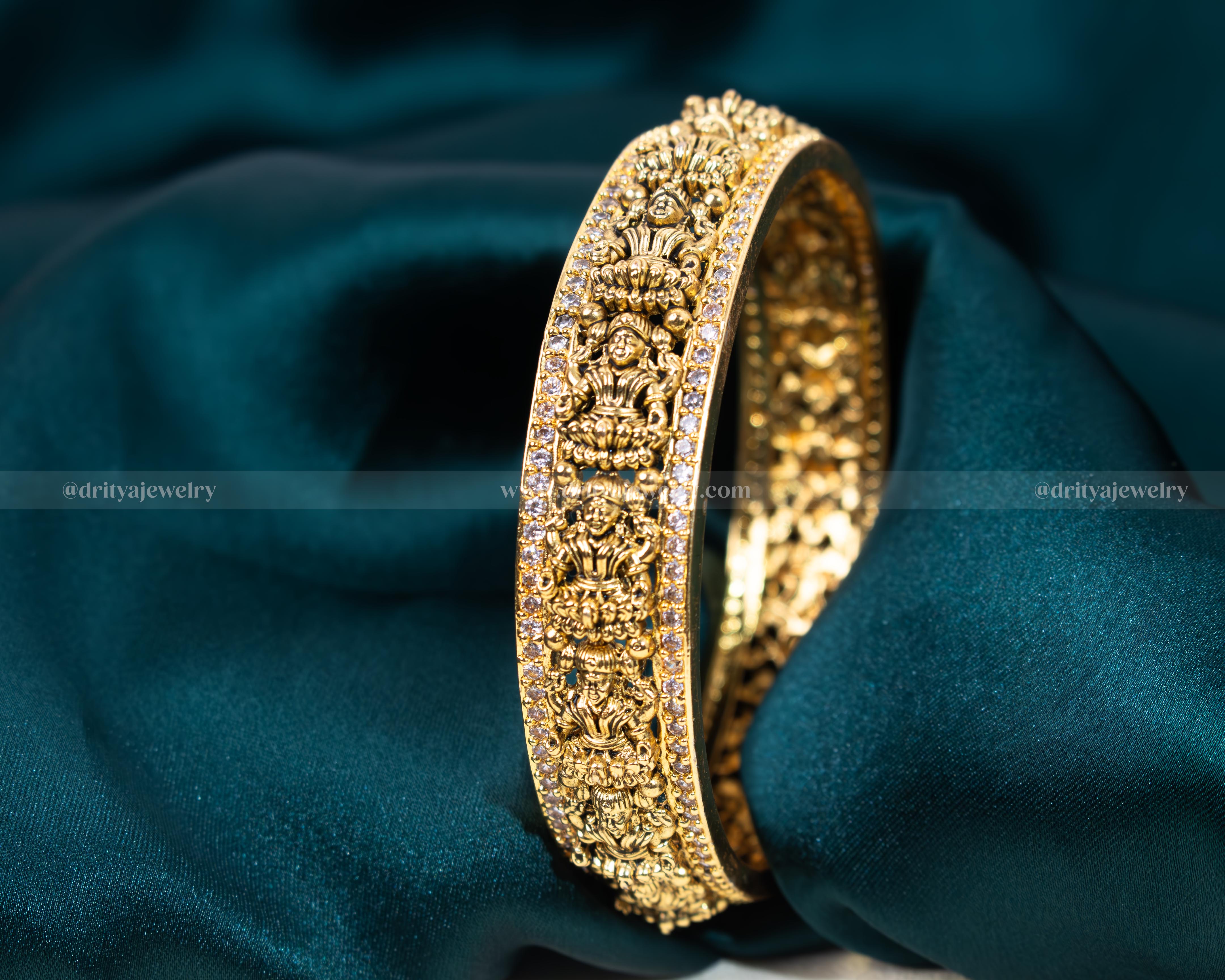 Exquisite Nakshi CZ Stone Bangle from Dritya Jewelry, featuring detailed carvings and sparkling CZ stones, perfect for weddings and cultural festivities.