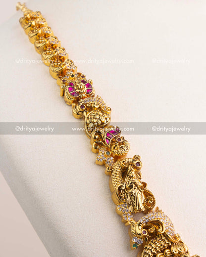 Detailed view of long necklace chain with temple motifs, peacocks, and floral carvings.