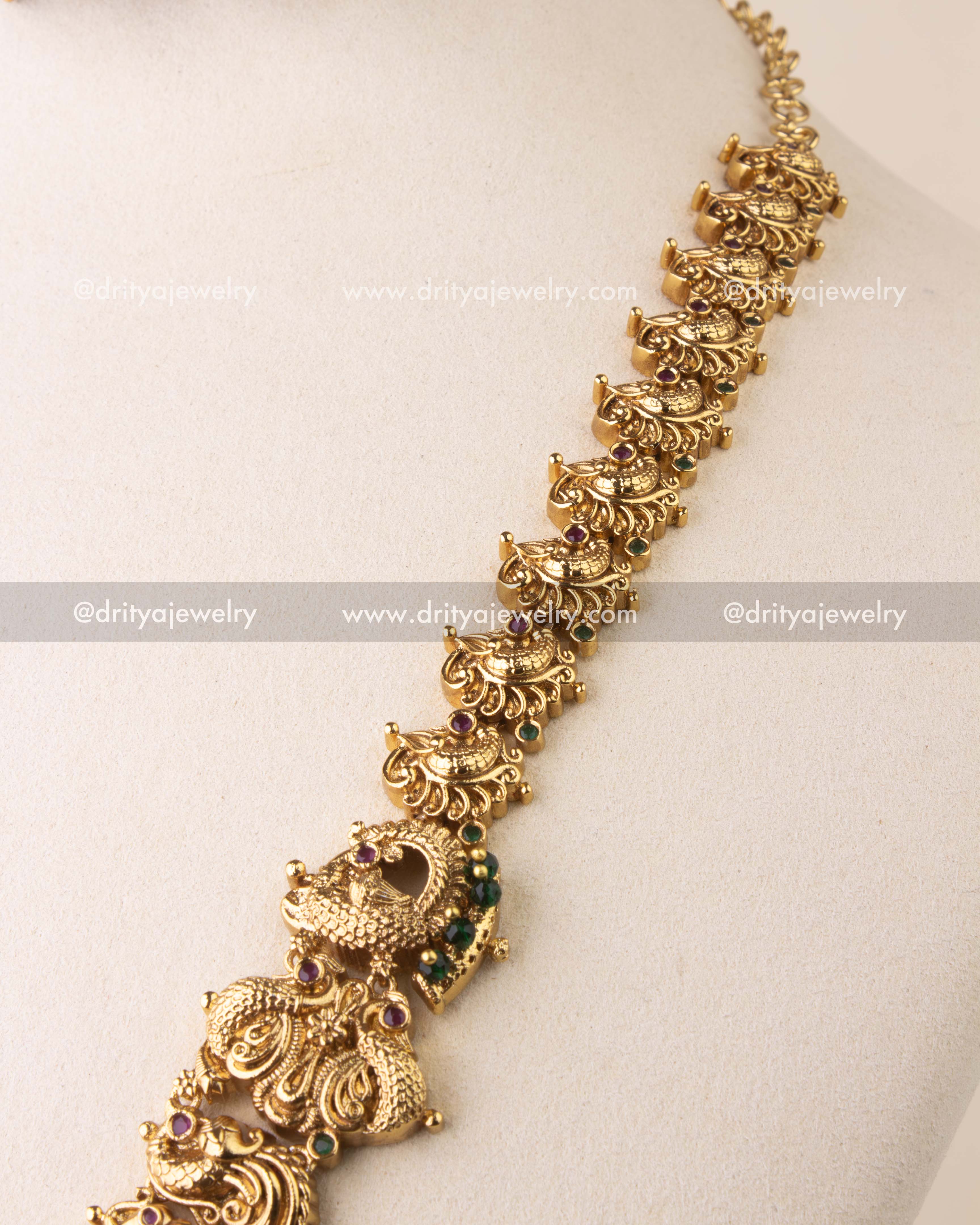 Detailed temple chain featuring elephant and peacock carvings with antique finish.