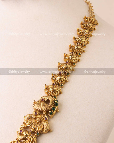 Detailed temple chain featuring elephant and peacock carvings with antique finish.