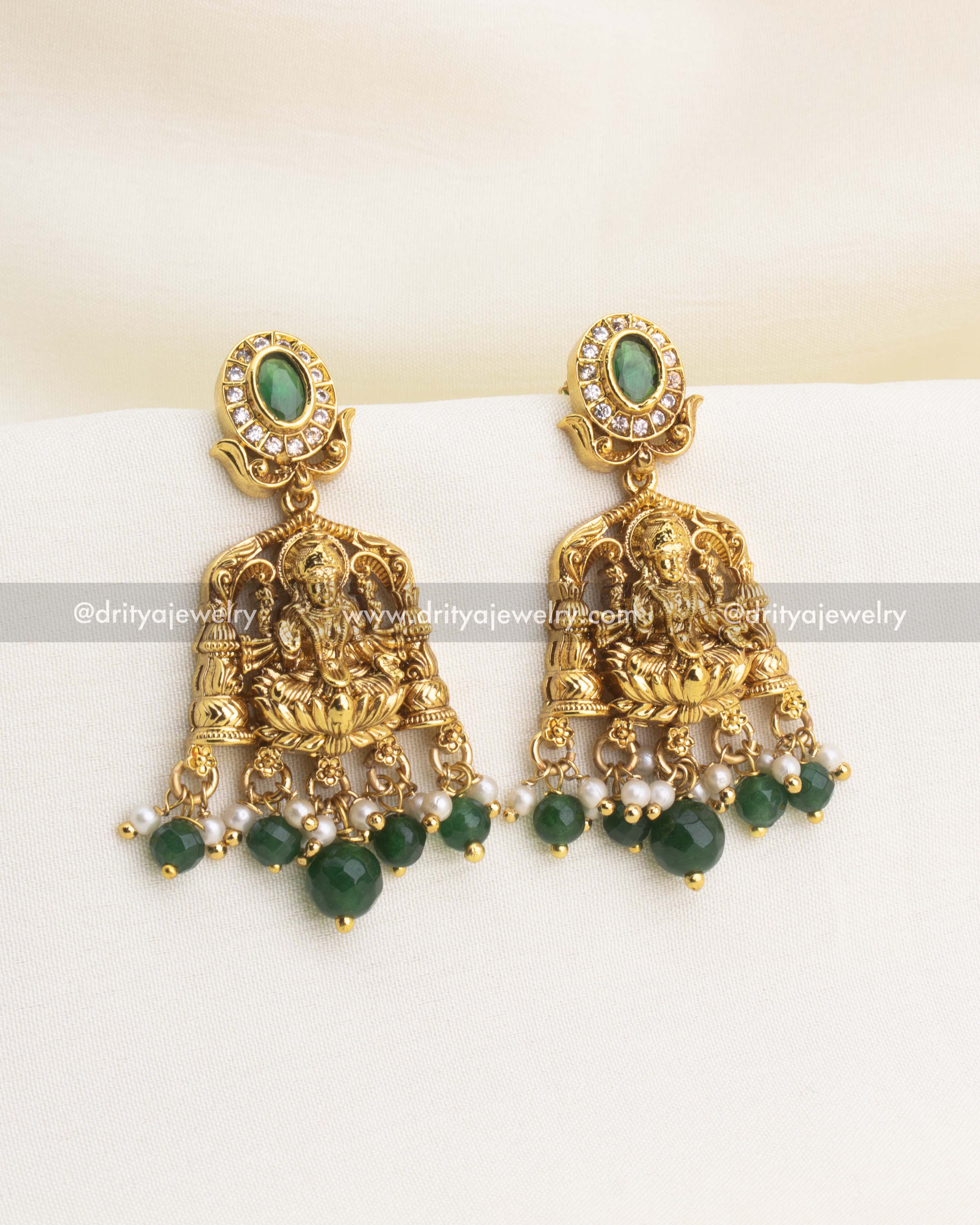 Temple-style earrings with Lakshmi carving, CZ accents, and green bead drops.