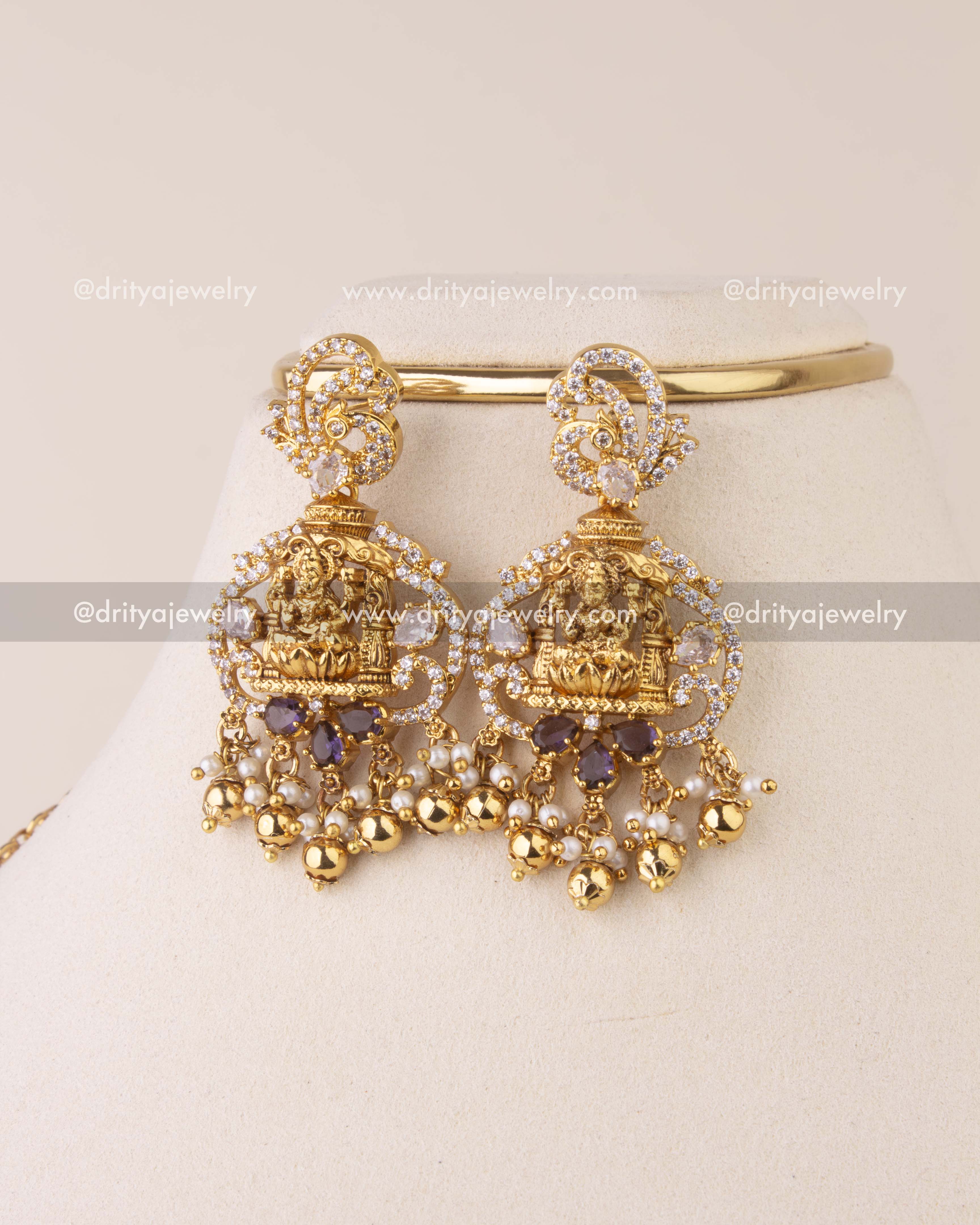 Traditional earrings featuring Lakshmi motif with CZ stones and gold bead drops.