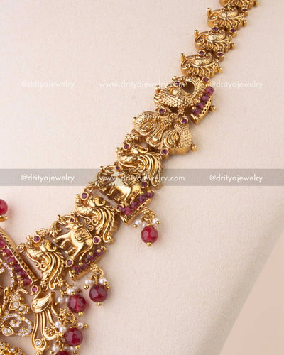 Traditional Nakshi chain with detailed motifs and ruby bead finish.