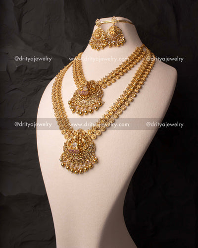 Traditional Nakshi-style gold-plated necklace set featuring intricate temple motifs, a Lakshmi Devi pendant, and matching earrings.