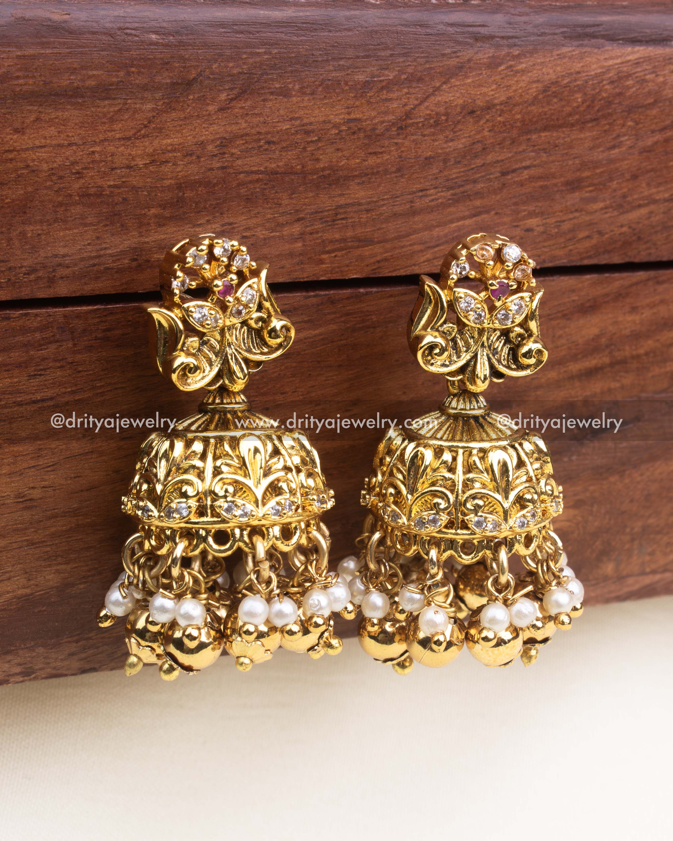 Antique gold jhumka earrings with floral top and gold ball drops.