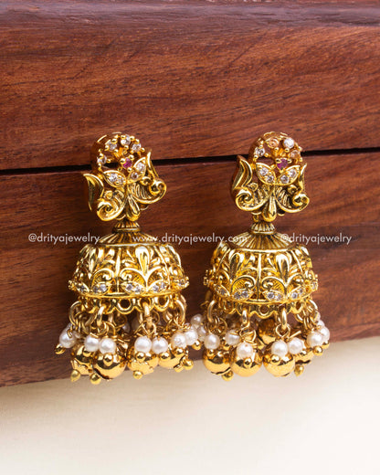 Antique gold jhumka earrings with floral top and gold ball drops.