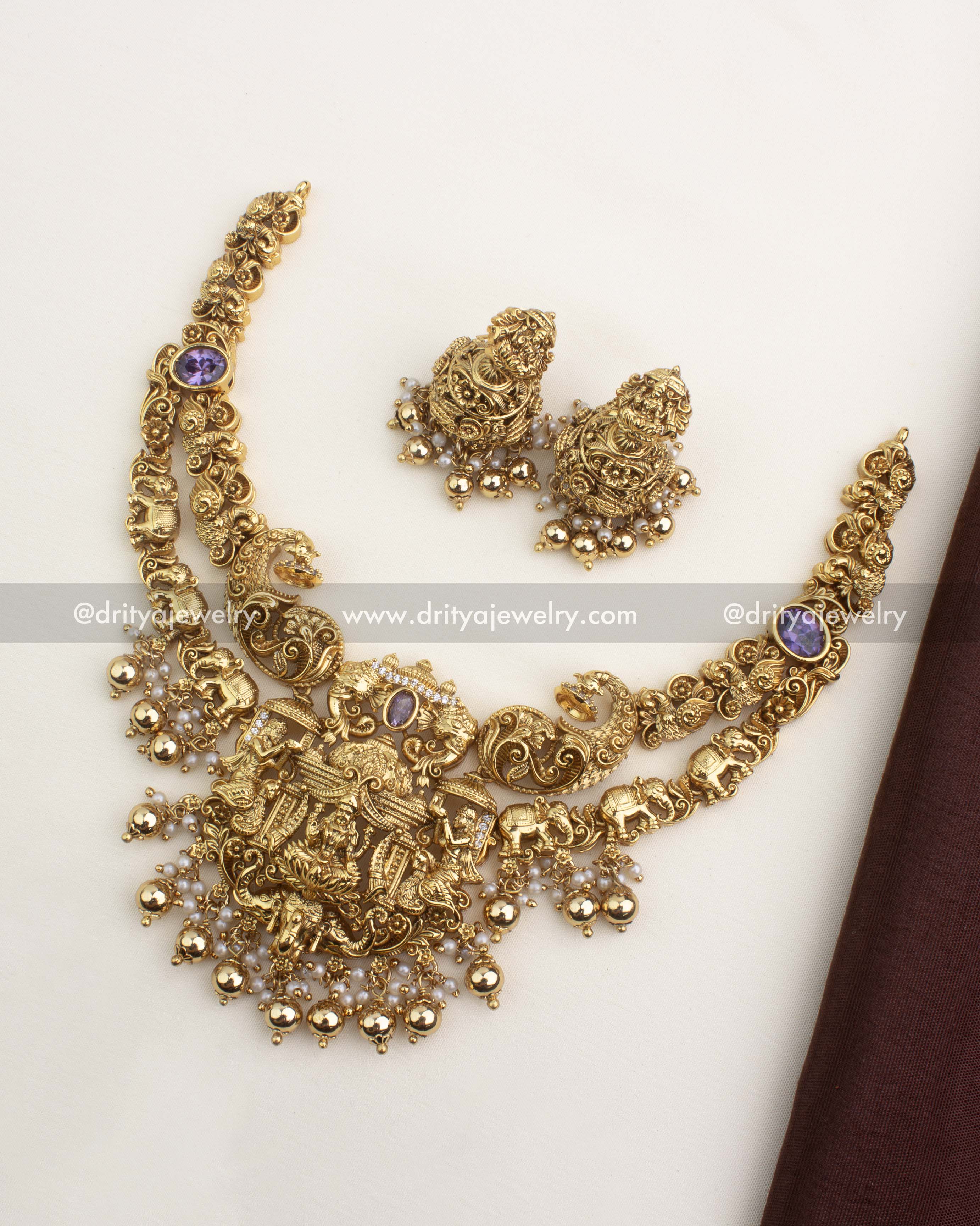 Premium nakshi short necklace set with temple pendant and matching jhumkas in antique gold finish.