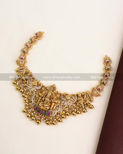 Premium antique gold Nakshi necklace featuring Lakshmi Devi motif with gemstone and pearl accents.